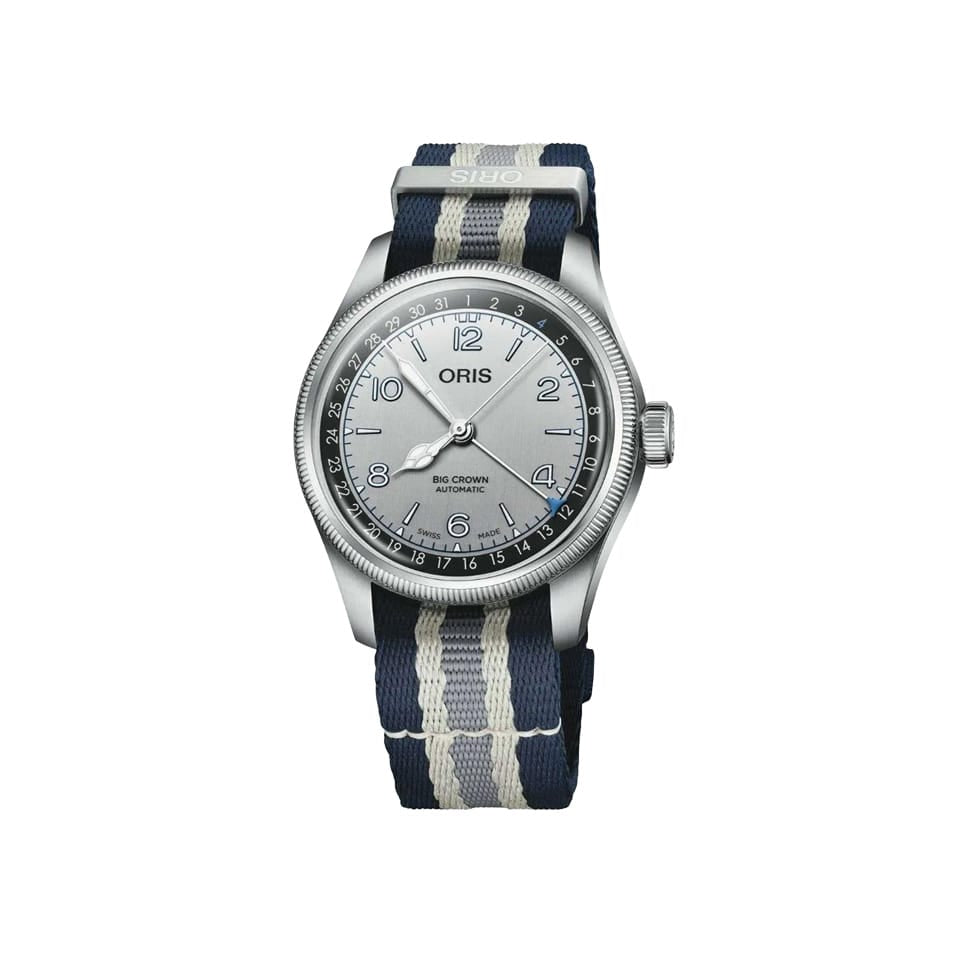 An Oris watch with a silver stainless steel case, a silver dial with black markings, and a navy blue and white striped fabric strap, shown against a plain white background.