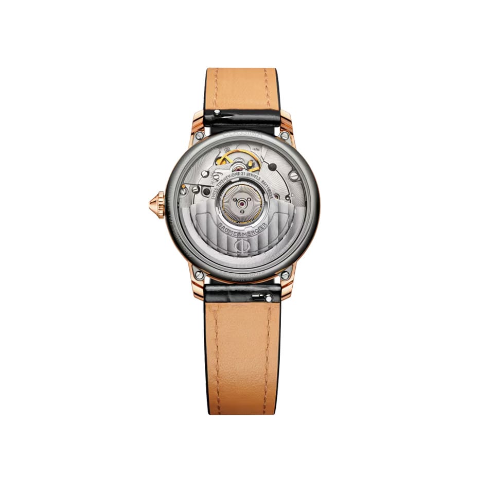 Rear-facing view of the Baume & Mercier Classima M0A10598, showing the transparent sapphire crystal case back revealing the automatic ETA 2892-A2 movement, framed by the polished 18K pink gold and titanium case.
