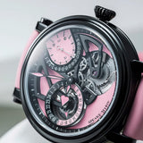 Close up of the Speake Marin Openworked Dual Time Pink Automatic GMT 42mm Watch 414209430 dial, showing the 24-hour Home Time indication in black and pink at 9 o'clock. Pink lacquered heart-shaped hands sweep above the small seconds and retrograde date at 1:30.