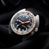 Front view of DOXA SUB 300 Ti5 Sharkhunter watch, 42.5mm grade 5 titanium cushion case, black dial with oversized orange minute hand, patented dual-scale dive bezel, screw-down crown, and black rubber strap with folding clasp — Ref. 823.50.101.20