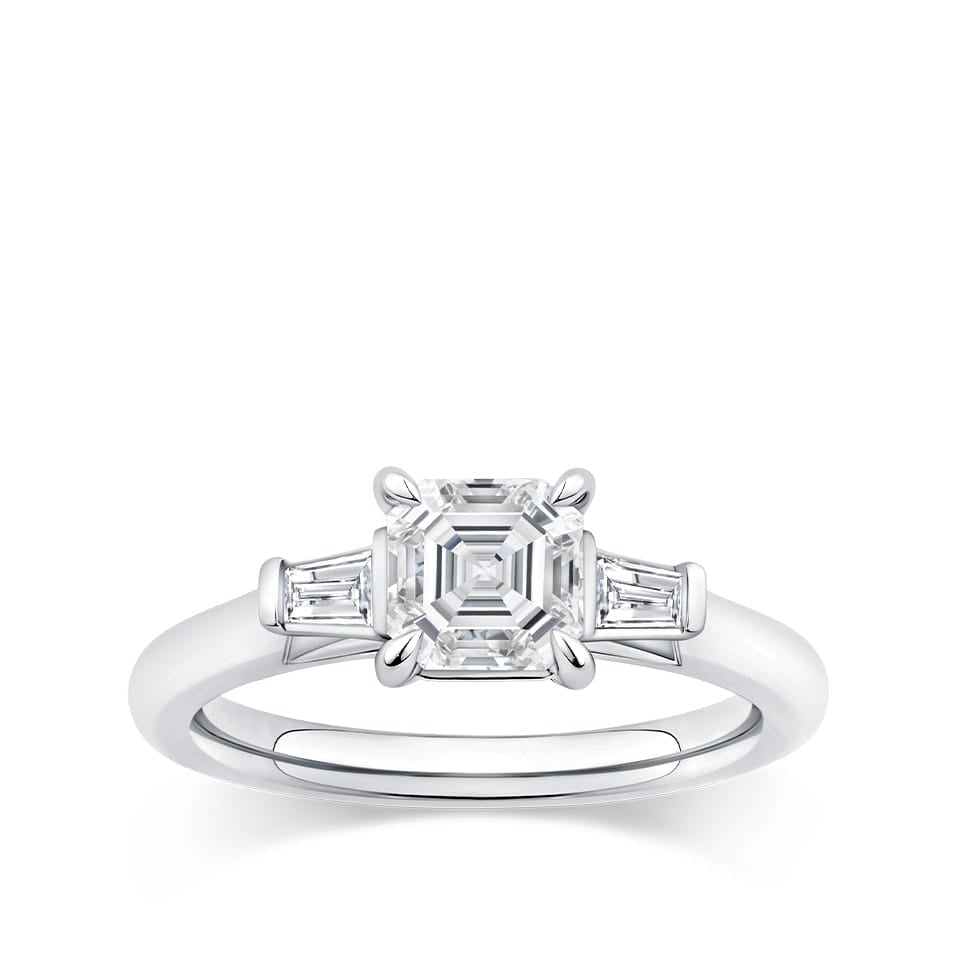 0.96 Carat Asscher Cut Diamond and Tapered Baguette Trilogy Ring in 18ct white gold from Hardy Brothers Jewellers, shown front-on with the Asscher cut centre diamond and tapered baguette side stones.