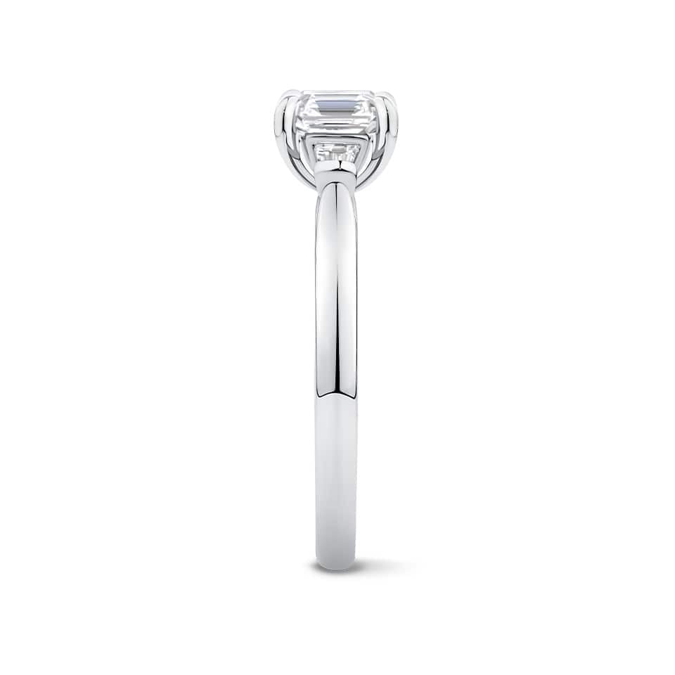 Close-up detail of the Trilogy Ring in 18ct white gold by Hardy Brothers, highlighting the claw-set Asscher cut diamond and tapered baguette detailing.