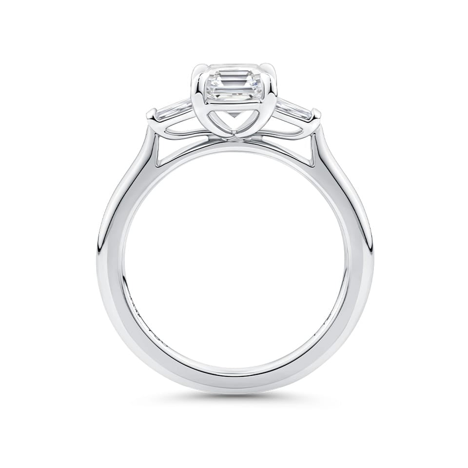 Close-up detail of the Trilogy Ring in 18ct white gold by Hardy Brothers, highlighting the claw-set Asscher cut diamond and tapered baguette detailing.