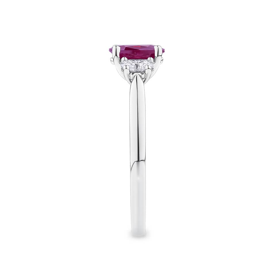 1.15 Carat Burmese Ruby and 0.40ct TW Diamond Ring in 18ct White Gold — This side profile highlights the ring's tapered gallery and the natural oval-cut diamonds along the shoulders. The 18ct white gold band maintains a slim, elegant silhouette from every angle.