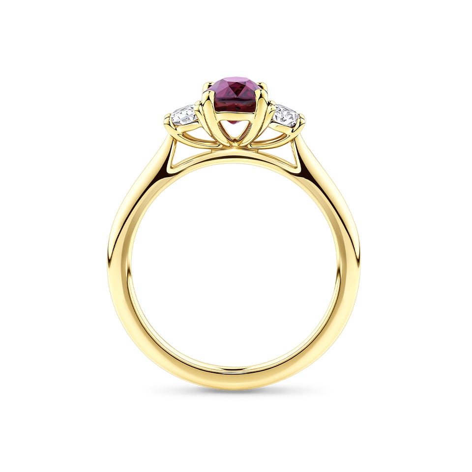1.37 Carat Ruby and 0.40ct TW Diamond Trilogy Ring in 18ct Yellow Gold — Viewed from the front, the ring showcases its classic trilogy design with the ruby set prominently above a diamond-lined band. The 18ct yellow gold setting offers a warm, rich contrast to the ruby's deep tone.