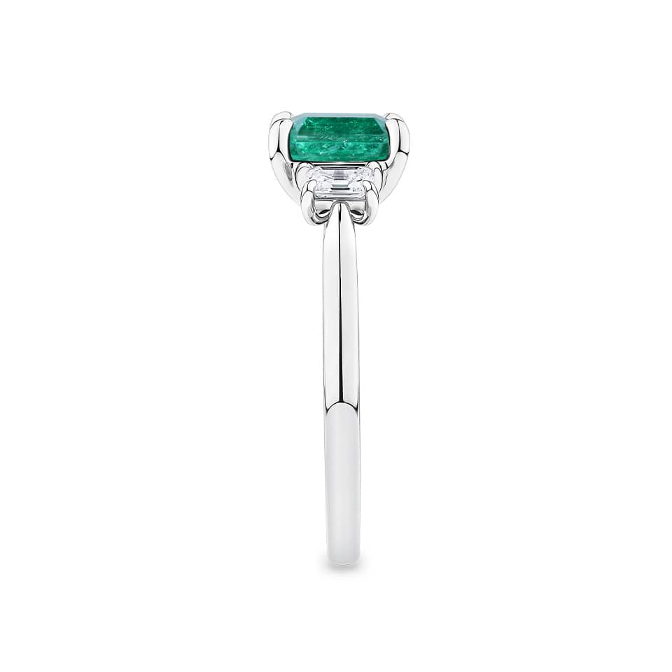 1.81 Carat Emerald and 0.30 Carat TW Diamond Trilogy Ring in 18ct White Gold — This side profile highlights the ring's tapered gallery and the natural emerald-cut diamonds set along each shoulder. The 18ct white gold band maintains a slim, elegant silhouette from every angle.