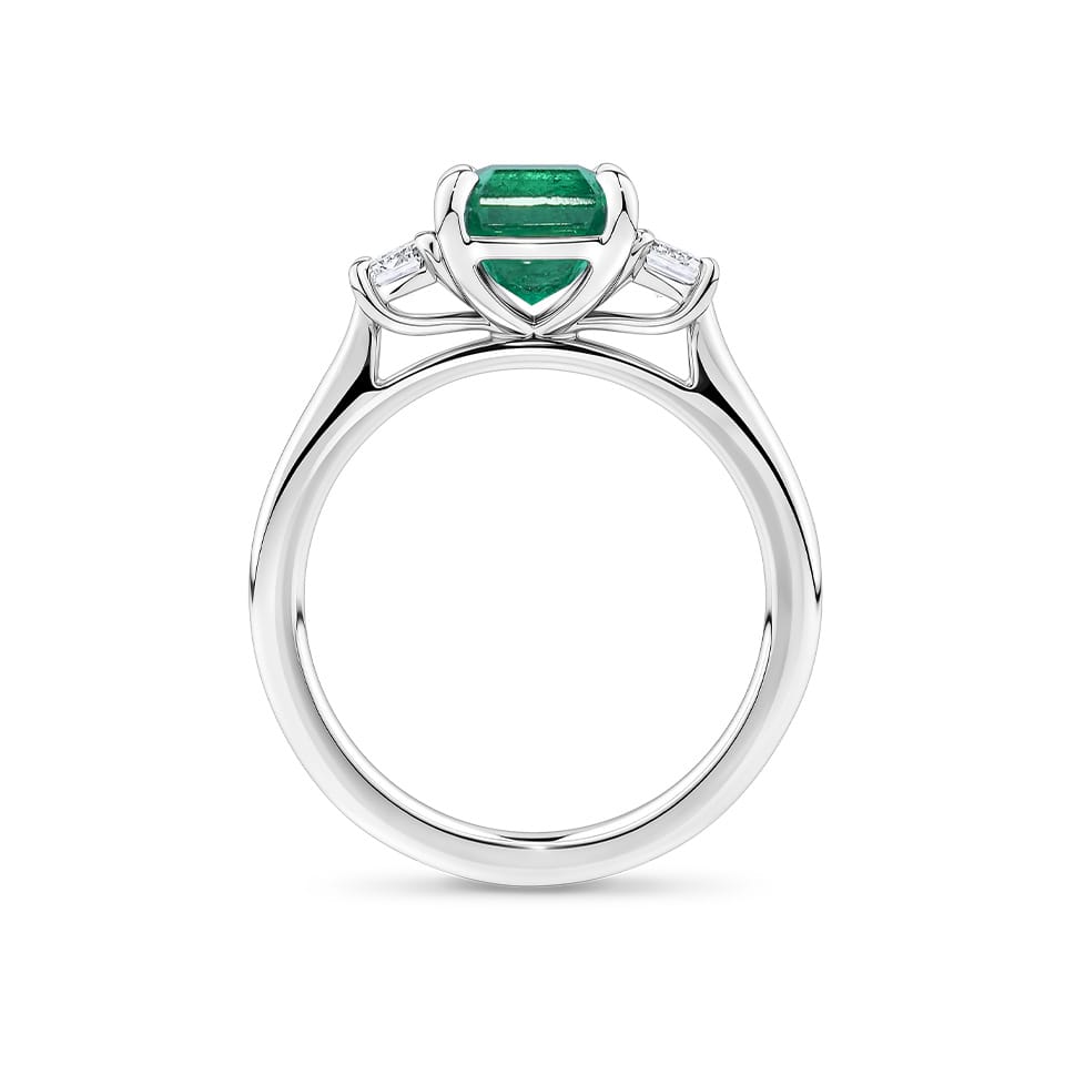 1.81 Carat Emerald and 0.30 Carat TW Diamond Trilogy Ring in 18ct White Gold — Viewed from the front, the ring showcases its trilogy design with the emerald-cut emerald set above matching emerald-cut diamonds on either side. The 18ct white gold setting frames the stones in a bright, cool tone.