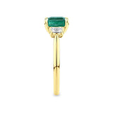 2.10 Carat Emerald and 0.40 Carat TW Diamond Trilogy Ring in 18ct Yellow Gold — This side profile highlights the ring's tapered gallery and the natural emerald-cut diamonds set along each shoulder. The 18ct yellow gold band maintains a slim, elegant silhouette from every angle.