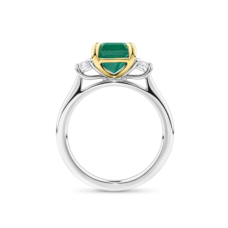 2.54 Carat Emerald and 0.40 Carat TW Diamond Trilogy Ring in 18ct Yellow and White Gold — Viewed from the front, the ring showcases its trilogy design with the claw-set emerald above matching emerald-cut diamonds on either side. The two-tone 18ct yellow and white gold setting highlights each stone's distinct colour.