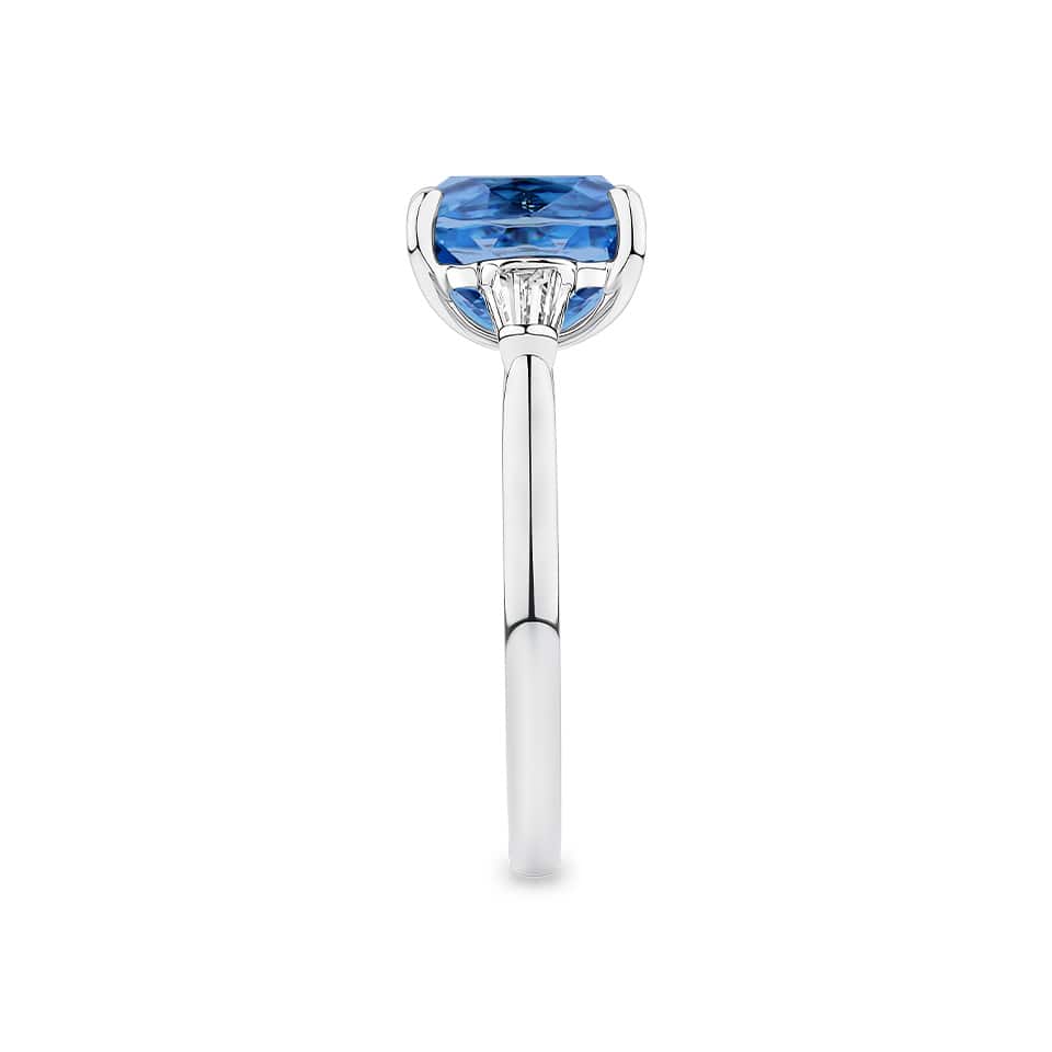 4.62 Carat Zircon and 0.36 Carat TW Diamond Trilogy Ring in 18ct White Gold — This side profile highlights the ring's tapered gallery and the tapered baguette diamonds set along each shoulder. The 18ct white gold band maintains a slim, elegant silhouette from every angle.