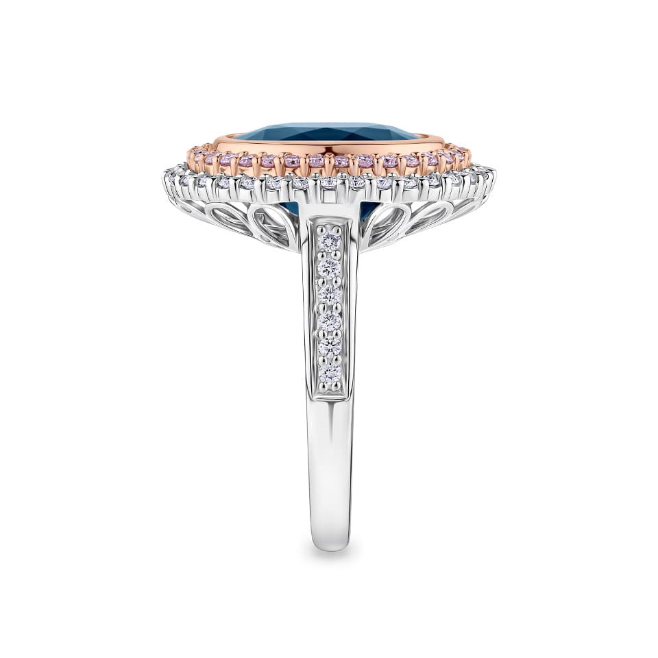 7.66 Carat Sapphire and 1.04 Carat TW Diamond Halo Ring in 18ct Rose and White Gold — This side profile highlights the ring's layered halo design and the grain-set white diamonds tracing each shoulder of the white gold band. The two-tone setting maintains a bold, elegant silhouette from every angle.