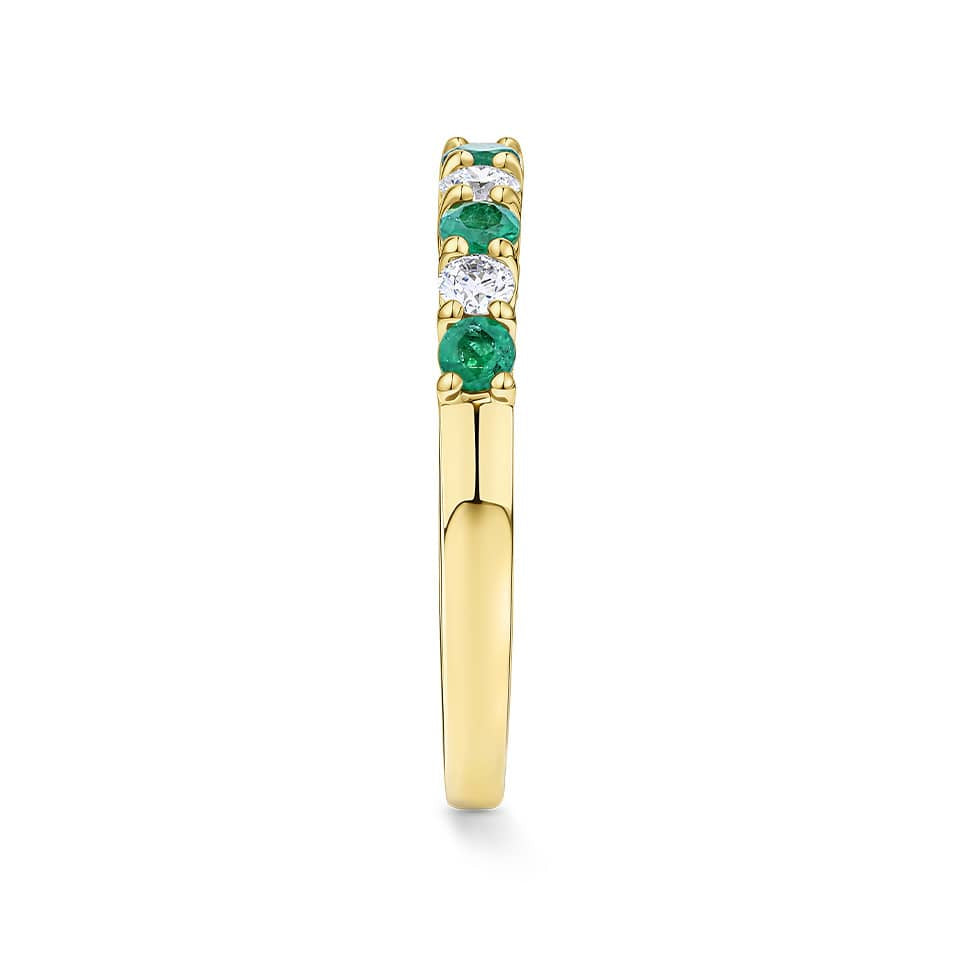 Side view of the Emerald and Diamond Alternating Ring in 18ct yellow gold by Hardy Brothers, highlighting the claw-set stones and polished band.