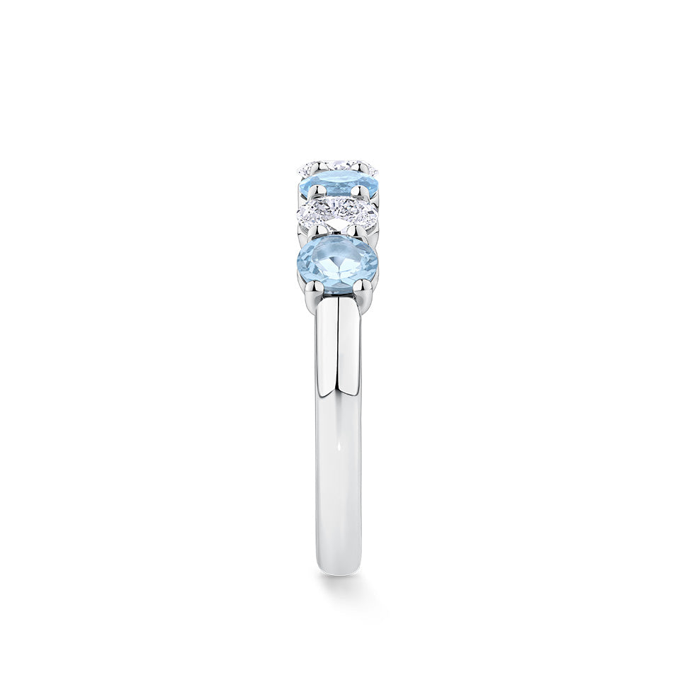 Top-down view of the Aquamarine and Diamond Half Eternity Ring in 18ct white gold by Hardy Brothers, showing the alternating row of oval cut aquamarines and diamonds across the top of the band.