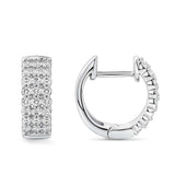 Quintessential Diamond Huggie Hoop Earrings in 18ct white gold by Hardy Brothers, one earring tilted to show the hoop shape and clip-in clasp.