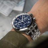 Breitling Classic AVI Automatic Chronograph 42mm Watch A233801A1C1A1 is shown worn on the wrist, highlighting the proportions of its 42mm case and stainless steel bracelet. This COSC-certified chronograph is powered by the Breitling Caliber 23 with an approximate 48-hour power reserve.
