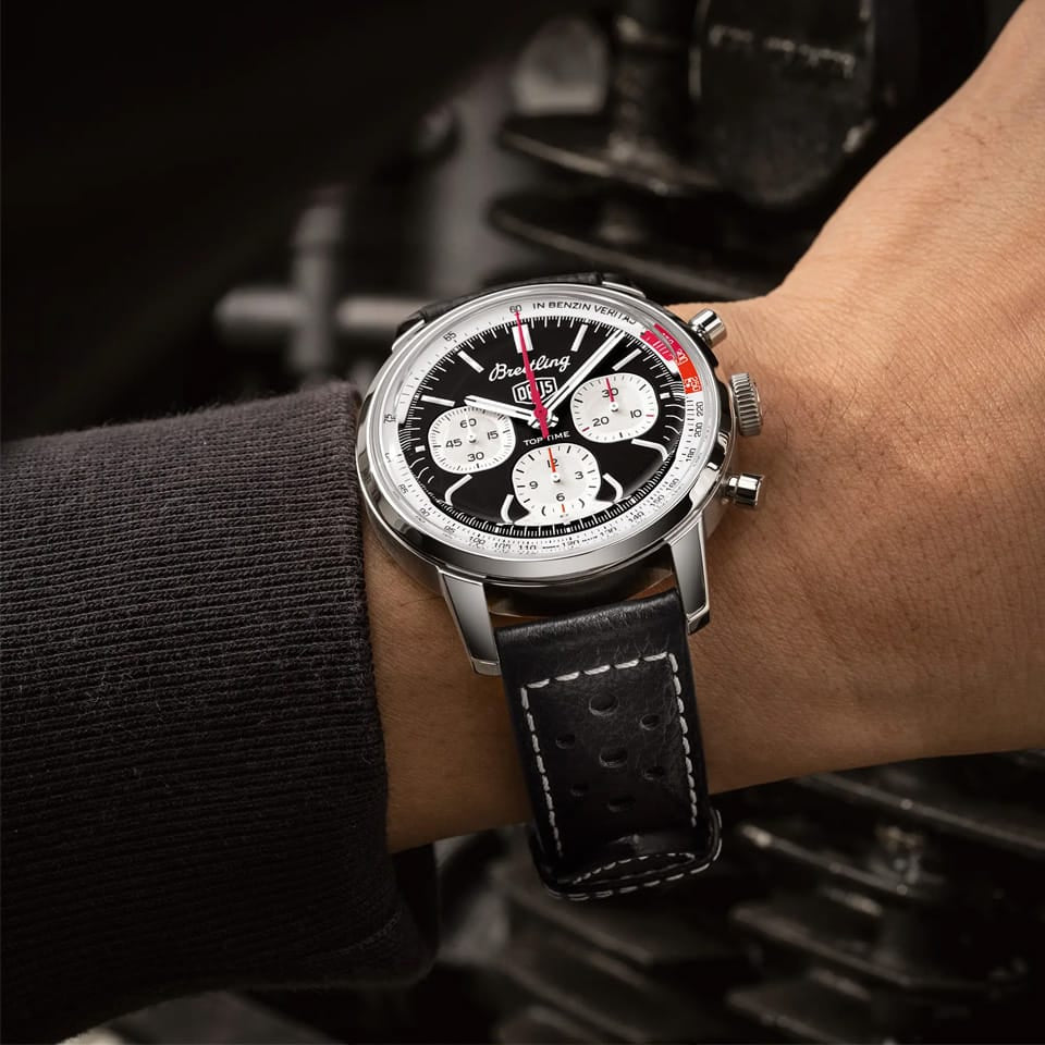 Breitling Top Time Deus B01 Chronograph 41mm Watch AB01765A1B1X1 is shown worn on the wrist, highlighting the proportions of its 41mm case and perforated racing strap. This chronograph is powered by the Breitling Manufacture Caliber 01 with an approximate 70-hour power reserve.