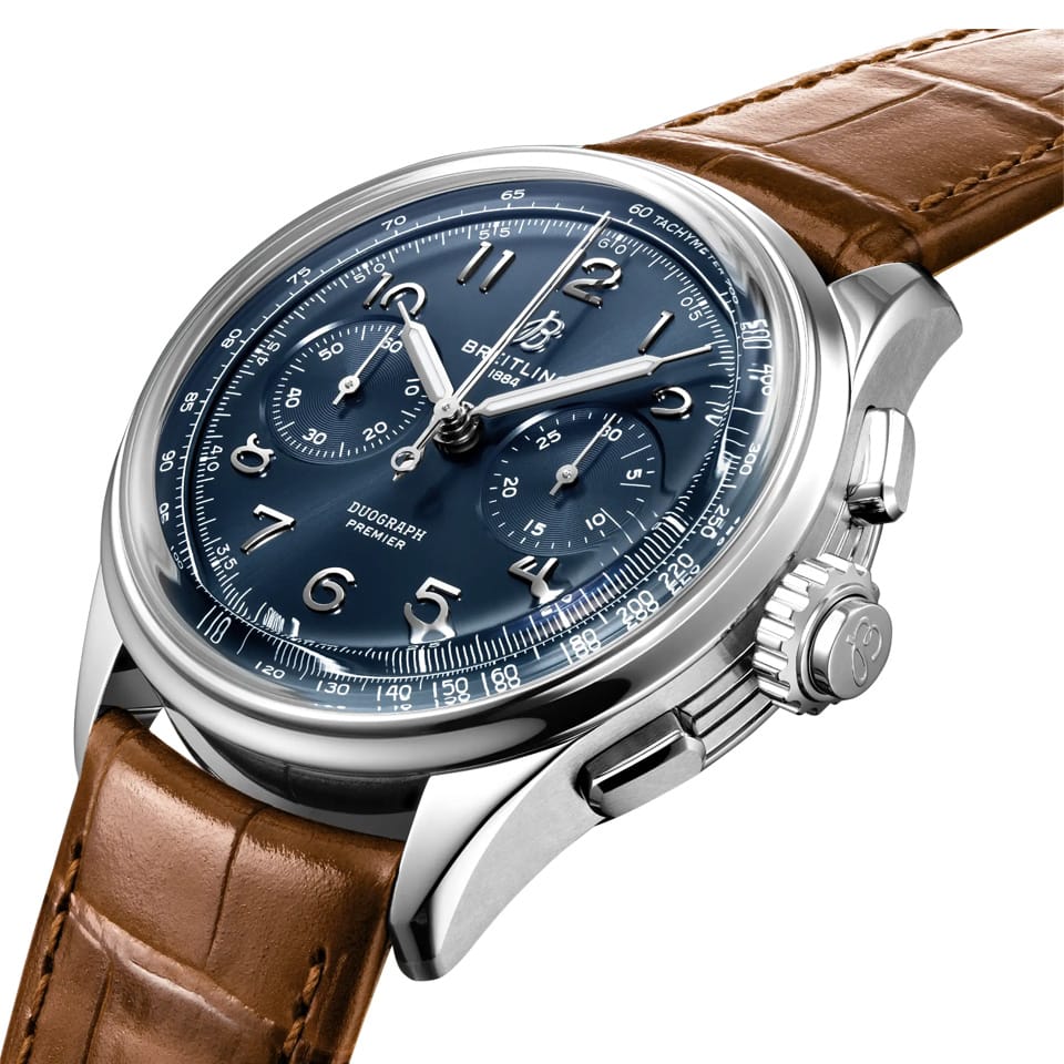 Breitling Premier B15 Duograph 42mm Watch AB1510171C1P1 shows the grooved case-sides and cambered sapphire crystal from an angled perspective. The gold brown alligator strap curves into the 42mm stainless steel case for a refined silhouette.