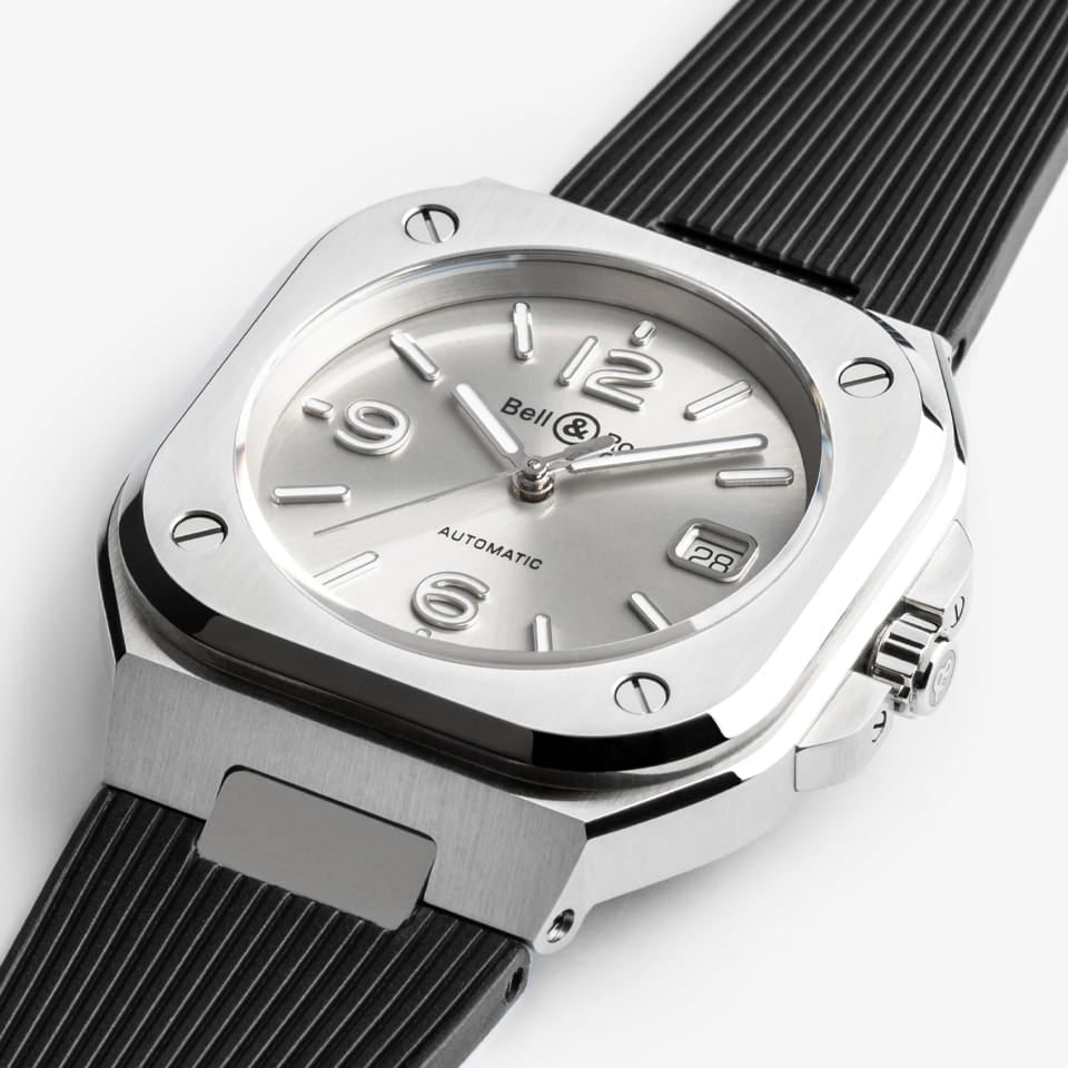 Bell & Ross BR-05 Automatic 40mm Men's Watch, reference BR05A-GR-ST/SRB, captured in side profile to highlight the alternating satin-finished and polished bevels of the steel case. The black rubber strap tapers cleanly from the integrated case design.