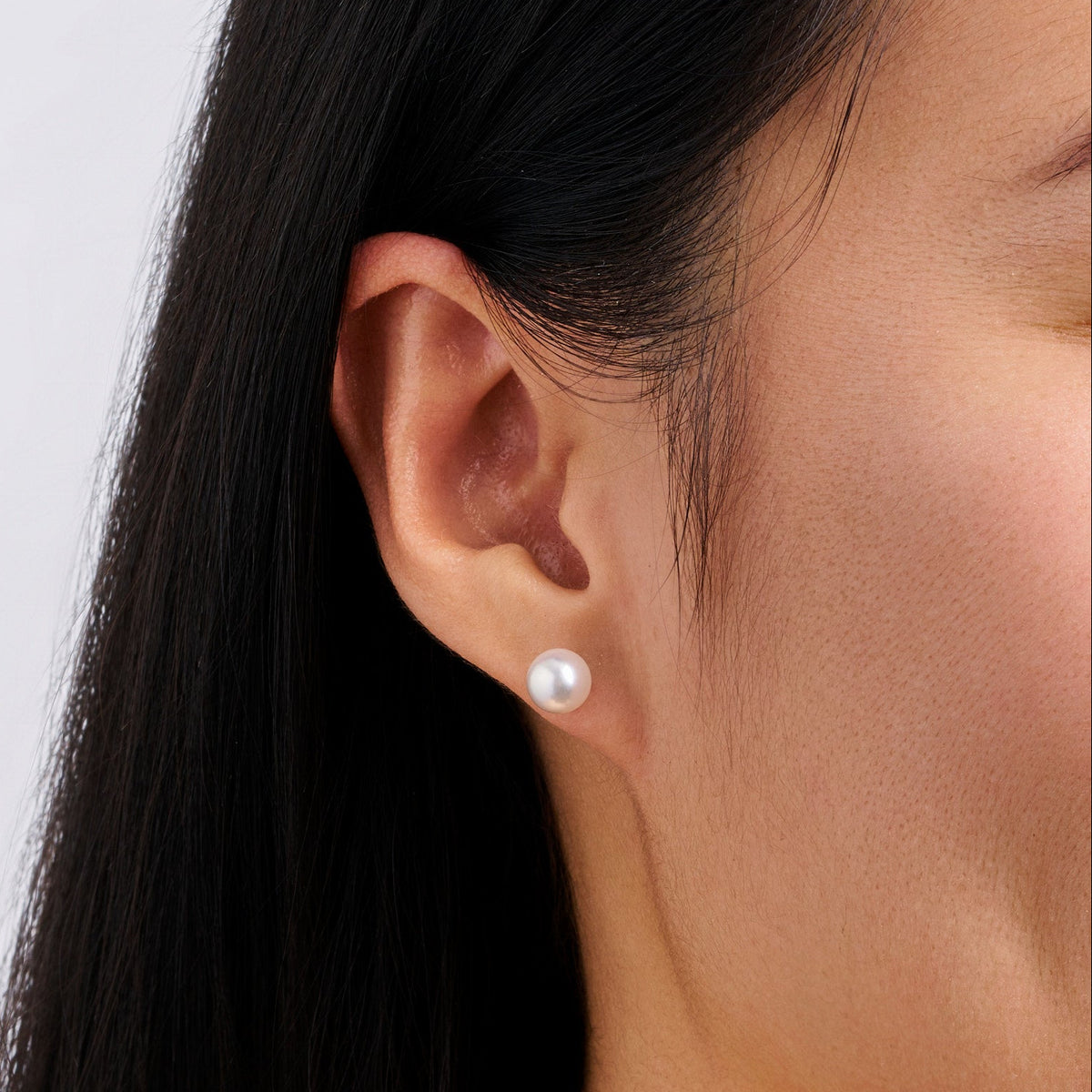 Close-up of the Akoya Pearl Stud Earrings in 18ct white gold by Hardy Brothers, showing the smooth surface and lustre of the 7mm white pearl.