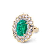 VAULT 7.55 CARAT OVAL CUT COLOMBIAN EMERALD AND 2.90 CARAT DIAMOND HALO RING IN 18CT YELLOW GOLD