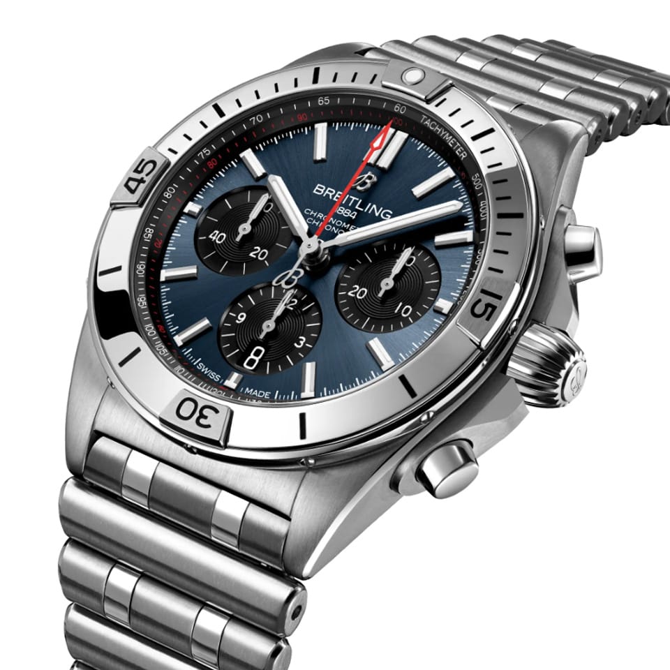 Breitling Chronomat B01 Chronograph 42mm Watch AB0134101C1A1 shows the unidirectional ratcheted bezel and cambered sapphire crystal from an angled perspective. The signature Rouleaux bracelet connects seamlessly to the 42mm case.