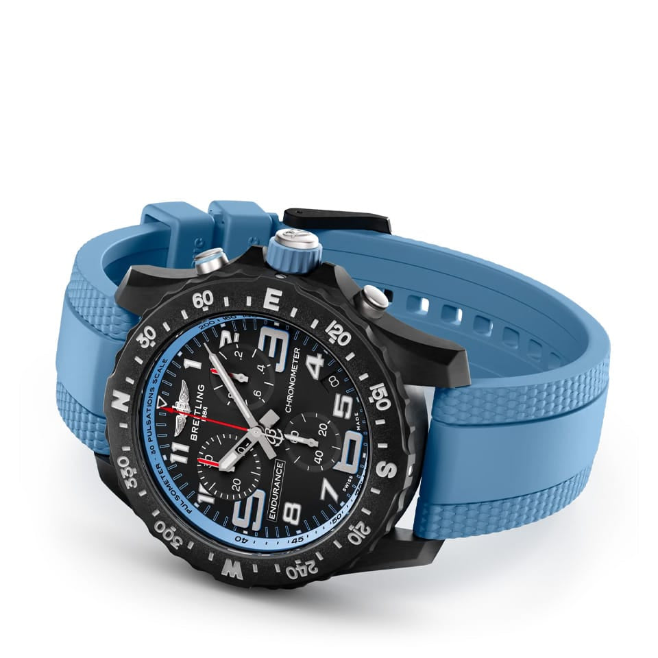 Breitling Endurance Pro Quartz Chronograph 44mm Watch X82310281B1S2 reveals the detail of its blue rubber strap. The Breitlight® tang-type buckle matches the case material for a cohesive, lightweight design.