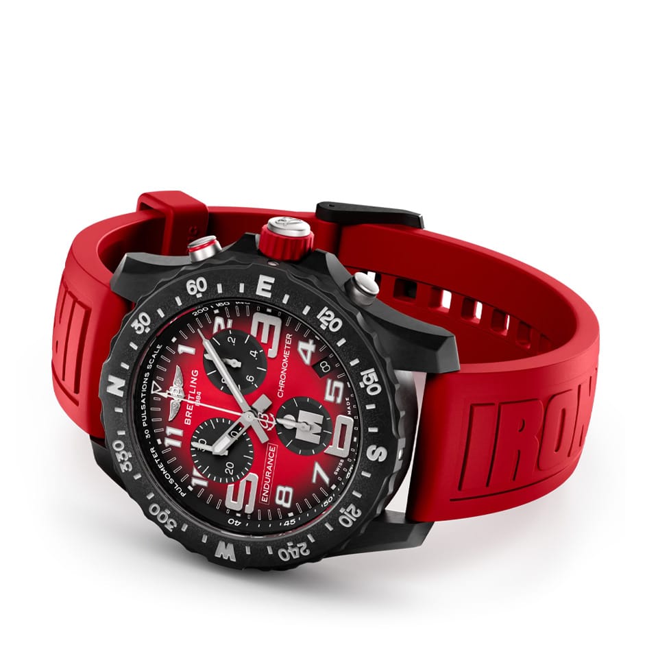 Breitling Endurance Pro Quartz Chronograph 44mm Watch X823109A1K1S1 reveals the detail of its red IRONMAN® branded rubber strap. The Breitlight® double tang-type buckle matches the case material for a cohesive, lightweight design.