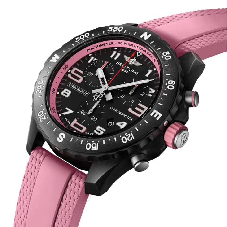 Breitling Endurance Pro Quartz Chronograph 38mm Watch X83310D41B1S1 shows the sapphire crystal and textured Breitlight® finish from an angled perspective. The pink rubber strap curves into the 38mm case for an athletic, everyday-wear profile.