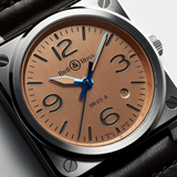 Bell & Ross BR-03 Automatic 41mm Men's Watch, reference BR03A-GB-ST/SCA, in close up detail of the gilt copper dial with skeletonised, Super-LumiNova-filled hour and minute hands. The automatic BR-CAL.302 movement powers the watch with a 54-hour power reserve.