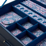 Close-up of the WOLF Sophia Indigo Jewellery Box interior, showing round charm storage spaces and ring rolls lined in Fruit Botanical print. The hand-printed design by Fiona Howard is visible across each compartment.