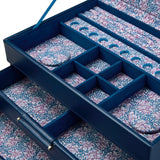 Close-up of the WOLF Sophia Indigo Jewellery Box interior, showing round charm storage spaces and ring rolls lined in Fruit Botanical print. The hand-printed design by Fiona Howard is visible across each compartment.