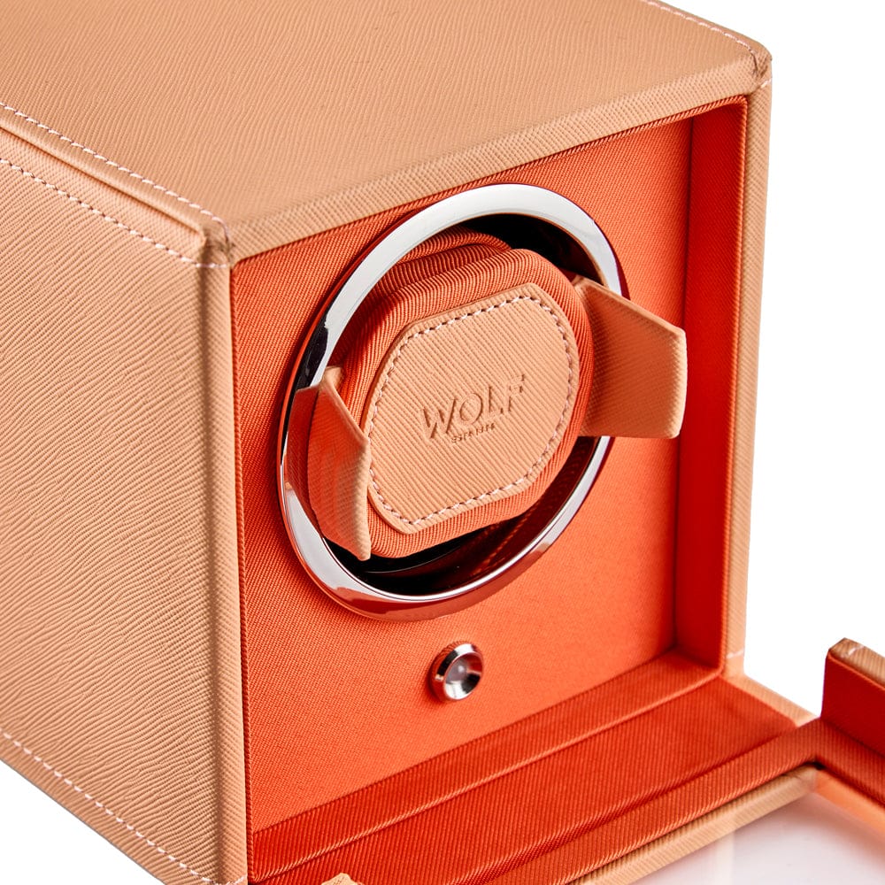 WOLF Cub Single Watch Winder with Cover in Orange, item 461162, showing its winding module up close. The patented lock-in cuff holds the watch securely in the rotator drum and suits all wrist sizes.