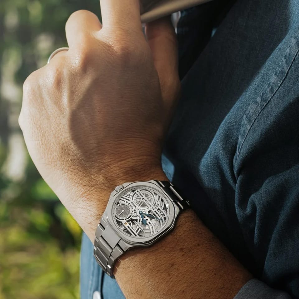 Speake Marin Ripples Skeleton Automatic 40.30mm Watch 604020150 worn on the wrist, highlighting its ultra-thin profile and integrated steel bracelet. The skeleton dial and black ripple-engraved small seconds counter at 1:30 sit beneath anti-reflective sapphire crystal.