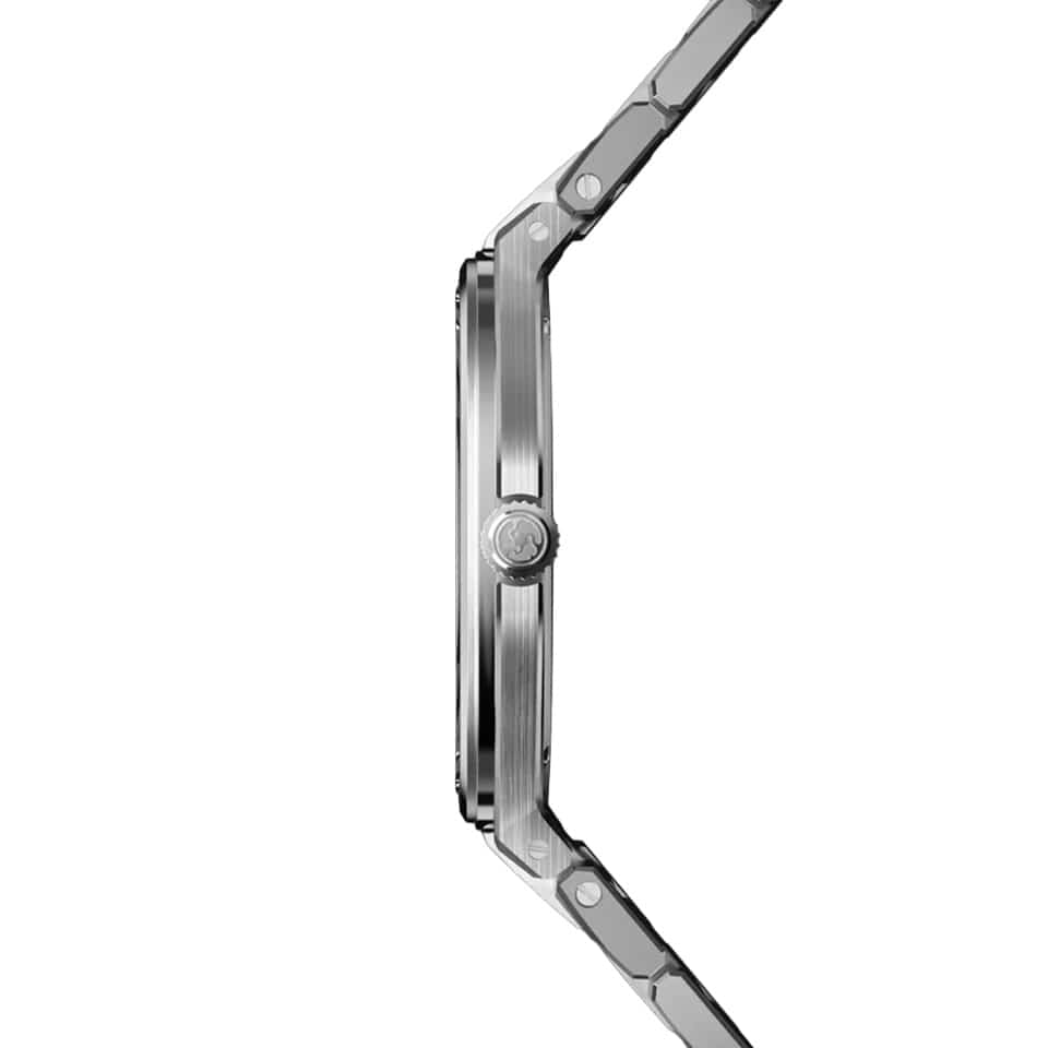 Side profile of the Speake Marin Ripples Skeleton Automatic 40.30mm Watch 604020150, showing its ultra-thin 904L stainless steel case and screw-down crown engraved with the Speake Marin logo. The polished case profile contrasts with the satin-finished bezel surface and the integrated bracelet links.
