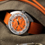 Front view of DOXA SUB 300 Ti5 Professional watch, 42.5mm grade 5 titanium cushion case, signature orange dial with oversized minute hand, patented dual-scale dive bezel, screw-down crown, and orange rubber strap with folding clasp — Ref. 823.50.351.21