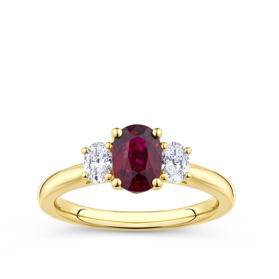 1.37 Carat Ruby and 0.40ct TW Diamond Trilogy Ring in 18ct Yellow Gold — A vivid oval-cut ruby sits at the heart of this trilogy design, flanked by two natural oval-cut diamonds of G-H colour and VS-SI clarity.