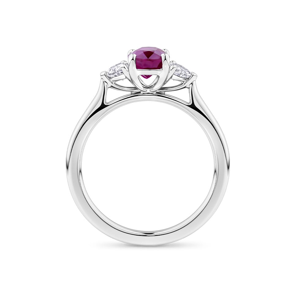 1.39 Carat Burmese Ruby and 0.36 Carat TW Diamond Trilogy Ring in 18ct White Gold — Viewed from the front, the ring showcases its trilogy design with the certified Burmese ruby set above two heart-cut diamonds, points aligned along the band. The 18ct white gold setting frames the stones in a bright, cool tone.