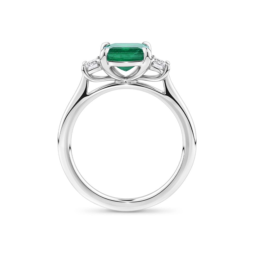 1.62 Carat Emerald and 0.40 Carat TW Diamond Trilogy Ring in 18ct White Gold — Viewed from the front, the ring showcases its trilogy design with the emerald-cut emerald set above matching emerald-cut diamonds on either side. The 18ct white gold setting frames the stones in a bright, cool tone.