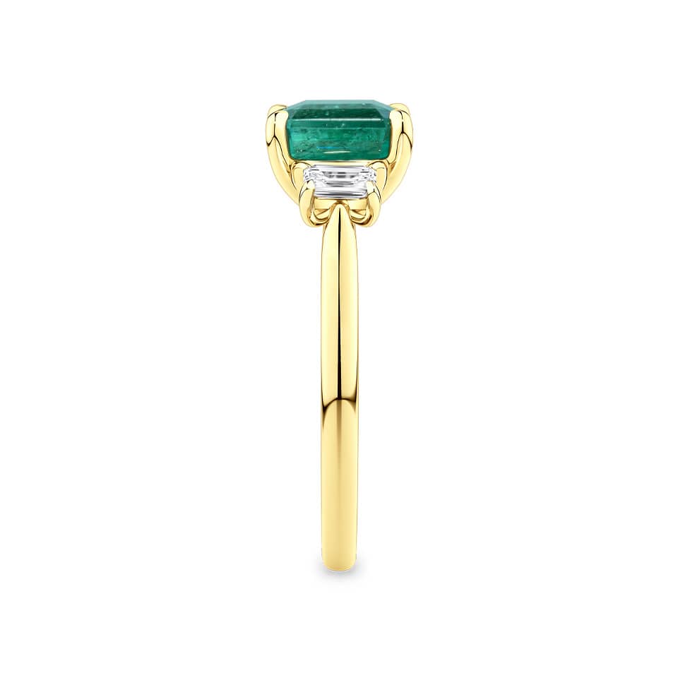 2.10 Carat Emerald and 0.40 Carat TW Diamond Trilogy Ring in 18ct Yellow Gold — This side profile highlights the ring's tapered gallery and the natural emerald-cut diamonds set along each shoulder. The 18ct yellow gold band maintains a slim, elegant silhouette from every angle.