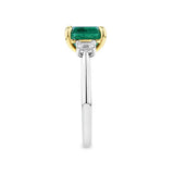 2.54 Carat Emerald and 0.40 Carat TW Diamond Trilogy Ring in 18ct Yellow and White Gold — This side profile highlights the ring's tapered gallery, the yellow gold claws around the emerald, and the natural emerald-cut diamonds along each shoulder. The two-tone band maintains a slim, elegant silhouette from every angle.