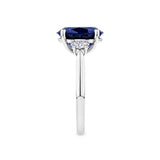 5.54 Carat Sapphire and 0.40 Carat TW Diamond Trilogy Ring in 18ct White Gold — This side profile highlights the ring's tapered gallery and the natural oval-cut diamonds set along each shoulder. The 18ct white gold band maintains a slim, elegant silhouette from every angle.