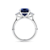 5.54 Carat Sapphire and 0.40 Carat TW Diamond Trilogy Ring in 18ct White Gold — Viewed from the front, the ring showcases its trilogy design with the oval-cut sapphire set above matching oval-cut diamonds on either side. The 18ct white gold setting frames the stones in a bright, cool tone.