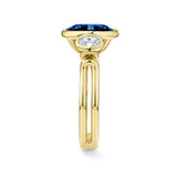 Side view of the Sapphire and Diamond Trilogy Ring in 18ct yellow gold by Hardy Brothers, highlighting the bezel-set sapphire and diamond side stones.