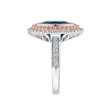 7.66 Carat Sapphire and 1.04 Carat TW Diamond Halo Ring in 18ct Rose and White Gold — This side profile highlights the ring's layered halo design and the grain-set white diamonds tracing each shoulder of the white gold band. The two-tone setting maintains a bold, elegant silhouette from every angle.