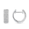 Quintessential Diamond Huggie Hoop Earrings in 18ct white gold by Hardy Brothers, one earring tilted to show the hoop shape and clip-in clasp.