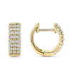 Quintessential Diamond Huggie Hoop Earrings in 18ct yellow gold by Hardy Brothers, one earring tilted to show the hoop shape and clip-in clasp.