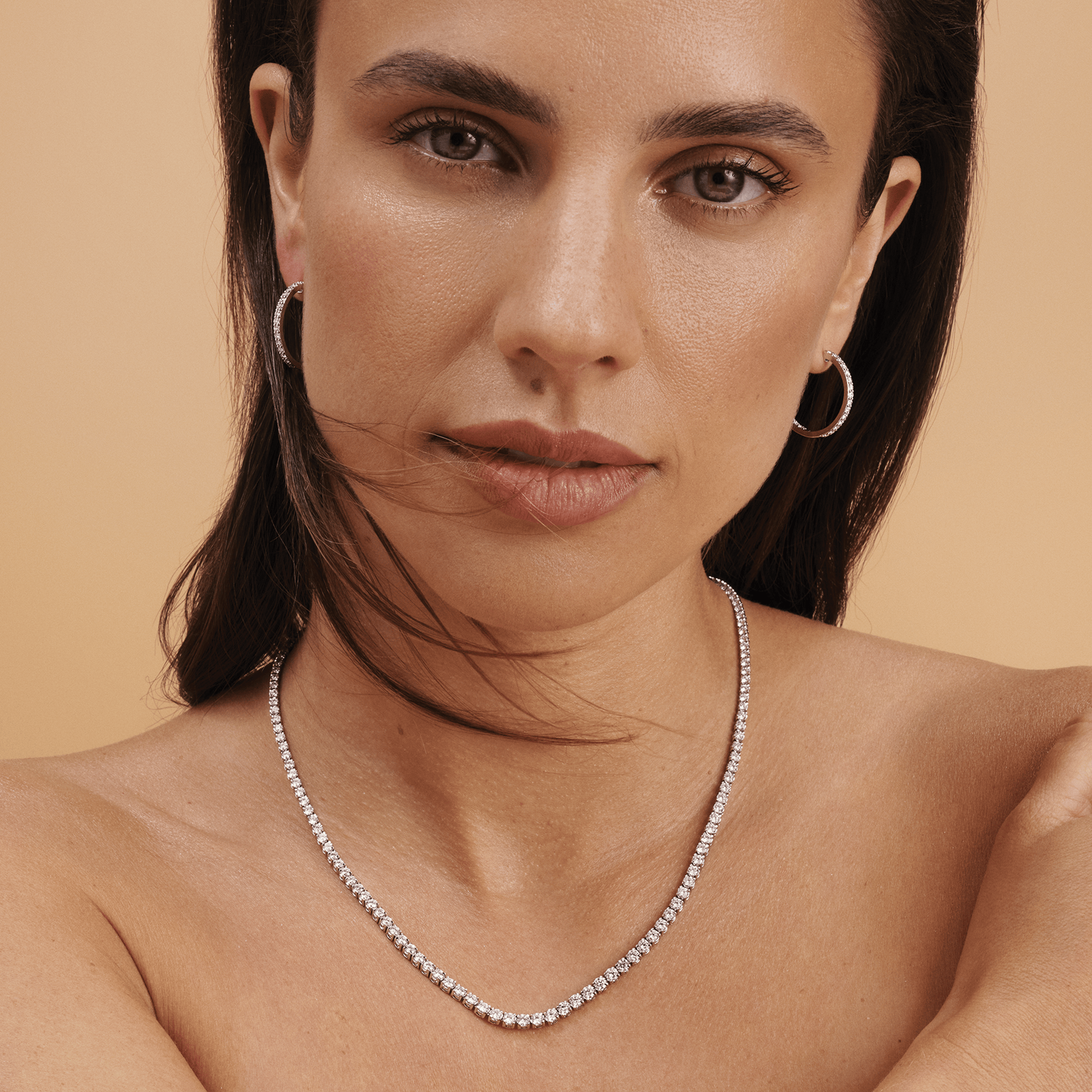 Quintessential 0.50 Carat Diamond Oval Huggie Earrings in 18ct White Gold