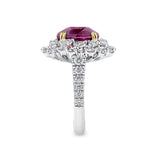 VAULT® 6.09 Carat TW Oval Cut Mozambique Ruby and 2.44 Carat TW Diamond Halo Ring in 18ct Yellow and White Gold — A side profile shows the diamond-set shank rising to meet the elevated ruby and halo setting. The two-tone gold construction is visible where the yellow gold claws meet the white gold mount.