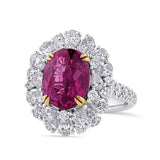 VAULT® 6.09 Carat TW Oval Cut Mozambique Ruby and 2.44 Carat TW Diamond Halo Ring in 18ct Yellow and White Gold — An oval cut Mozambique ruby sits at the centre, held by yellow gold claws within a scalloped double halo of pear and round brilliant cut diamonds. The diamond-set band continues the brilliance around the full shank.