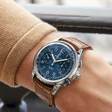 Breitling Premier B15 Duograph 42mm Watch AB1510171C1P1 is shown worn on the wrist, highlighting the proportions of its 42mm case and curved alligator strap. The split-second rattrapante chronograph function is powered by the COSC-certified Caliber B15 with an approximate 70-hour power reserve.